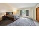 Bright bedroom with plush carpet, a bed, a nightstand and ample natural light at 10525 Hobbit Ln, Westminster, CO 80031
