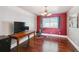 Multi-purpose room with hardwood floors, mini-fridge and large window at 10525 Hobbit Ln, Westminster, CO 80031