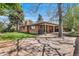 Brick ranch home with lush backyard, mature trees, patio, and inviting outdoor space at 2575 Quail St, Lakewood, CO 80215