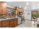 Bright kitchen featuring stainless steel appliances, granite countertops, and warm-toned wood cabinets at 2575 Quail St, Lakewood, CO 80215