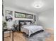 Serene main bedroom featuring stylish decor, hardwood floors, and natural light from large windows at 2575 Quail St, Lakewood, CO 80215