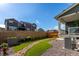Landscaped backyard featuring artificial grass, rock beds, and a wooden fence for added privacy at 17825 Gallup St, Broomfield, CO 80023