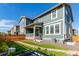 Landscaped backyard featuring artificial grass, rock beds, and a covered patio with natural light at 17825 Gallup St, Broomfield, CO 80023