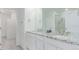 Bright bathroom features double sinks with granite countertops, modern fixtures, and walk-in shower access at 17825 Gallup St, Broomfield, CO 80023