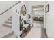 Inviting foyer with staircase, wood floors, and stylish decor, offering a warm welcome at 17825 Gallup St, Broomfield, CO 80023