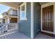 Charming front porch with a stylish front door, grey deck, and neat landscaping at 17825 Gallup St, Broomfield, CO 80023