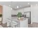 Modern kitchen with granite counters, stainless steel appliances, and breakfast bar seating at 17825 Gallup St, Broomfield, CO 80023