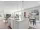 Bright, open kitchen featuring a granite island, stainless steel appliances, and adjacent dining area at 17825 Gallup St, Broomfield, CO 80023