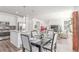 Open-concept living space with a dining area, kitchen, and comfortable seating arrangements at 17825 Gallup St, Broomfield, CO 80023