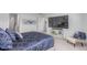 Well-lit main bedroom featuring a large TV and a comfortable chair, creating a relaxing space at 17825 Gallup St, Broomfield, CO 80023
