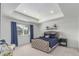 Inviting main bedroom with tray ceiling, large window, and stylish blue bedding and decor at 17825 Gallup St, Broomfield, CO 80023