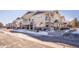 Street view of yellow townhouses, some with snow at 9335 Amison Cir # 201, Parker, CO 80134