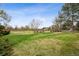 Expansive backyard with mature trees and manicured lawn offers privacy and space at 5145 S Logan Dr, Littleton, CO 80121
