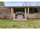 Covered brick patio with outdoor dining set accessible by brick steps and surrounded by lawn at 5145 S Logan Dr, Littleton, CO 80121