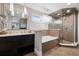 This primary bathroom features a freestanding tub and glass walk-in shower at 5145 S Logan Dr, Littleton, CO 80121