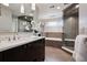 This primary bathroom features a double vanity and glass walk-in shower at 5145 S Logan Dr, Littleton, CO 80121