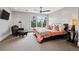 This bedroom boasts a sitting area, plush carpet, and serene views from the window at 5145 S Logan Dr, Littleton, CO 80121