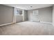 Neutral bedroom with soft carpet, bright windows, and baseboard heat at 5145 S Logan Dr, Littleton, CO 80121