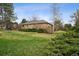 Brick home's backyard features mature landscaping, and a well-manicured lawn at 5145 S Logan Dr, Littleton, CO 80121