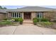 Charming home featuring a brick facade, manicured landscaping, and a welcoming front entrance with a brick walkway at 5145 S Logan Dr, Littleton, CO 80121
