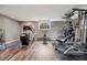 Bright home gym features wood floors, an elliptical, stationary bike and weight training machine at 5145 S Logan Dr, Littleton, CO 80121