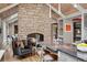 Kitchen with island seating, stone countertops, stone fireplace, and stainless steel appliances at 5145 S Logan Dr, Littleton, CO 80121