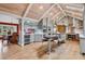 Spacious kitchen with gray cabinets, stainless steel appliances, island seating, and vaulted wood plank ceiling at 5145 S Logan Dr, Littleton, CO 80121