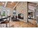 Bright open kitchen with a stone fireplace, vaulted ceilings, hardwood floors, and island seating at 5145 S Logan Dr, Littleton, CO 80121