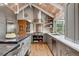 Bright eat-in kitchen with stainless steel appliances, gray cabinets, stone countertops, and wood plank cathedral ceilings at 5145 S Logan Dr, Littleton, CO 80121