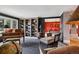 Well-appointed library with bookshelves and a piano flowing into an adjacent dining area at 5145 S Logan Dr, Littleton, CO 80121