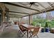 A full view shows a covered patio with views of outdoor seating, dining, and a kitchen pass-through for easy entertaining at 5145 S Logan Dr, Littleton, CO 80121
