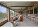 Full view of covered patio with an outdoor kitchen, multiple seating areas, and views of the surrounding landscape at 5145 S Logan Dr, Littleton, CO 80121