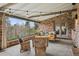 Relaxing outdoor patio featuring a porch swing with plush pillows and wicker seating, ideal for enjoying the peaceful surroundings at 5145 S Logan Dr, Littleton, CO 80121