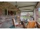 Inviting covered patio featuring brick accents, an outdoor kitchen pass-through, and ample seating, perfect for entertaining at 5145 S Logan Dr, Littleton, CO 80121