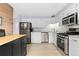 Kitchen with stainless steel appliances, white cabinets, and laminate floors at 11827 Brook Rd, Golden, CO 80403