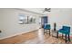 Inviting living room boasting hardwood floors, a large window, and a striking blue front door at 574 El Paso Rd, Palmer Lake, CO 80133
