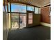 Enclosed back porch featuring multiple windows, carpet flooring, and access to the yard at 769 S Youngfield Ct, Lakewood, CO 80228