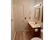 Cozy bathroom featuring wood-look floors, updated vanity, and a neutral color palette at 769 S Youngfield Ct, Lakewood, CO 80228