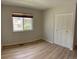 Bedroom featuring a window and large closet with modern flooring at 769 S Youngfield Ct, Lakewood, CO 80228