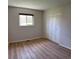 Bright bedroom with a large window and a spacious closet, complete with wood-look flooring at 769 S Youngfield Ct, Lakewood, CO 80228