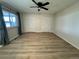 Spacious bedroom featuring a ceiling fan, ample closet space, and large window at 769 S Youngfield Ct, Lakewood, CO 80228