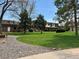Well-maintained community lawn with mature trees and landscaping, showcasing a peaceful environment at 769 S Youngfield Ct, Lakewood, CO 80228