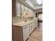 Bright kitchen featuring ample cabinet space and modern appliances with a view into the living room at 769 S Youngfield Ct, Lakewood, CO 80228