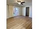 Open-concept living room with sliding glass doors, neutral paint, and laminate flooring at 769 S Youngfield Ct, Lakewood, CO 80228