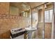 Stylish bathroom with tiled shower and pedestal sink, offering a clean and modern design at 1390 S Ammons St, Lakewood, CO 80232