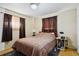 Comfortable bedroom featuring natural light and hardwood floors, creating a welcoming space to rest at 1390 S Ammons St, Lakewood, CO 80232