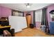 Bedroom with hardwood floors, ceiling fan, and window with privacy blinds and dark drapes at 1390 S Ammons St, Lakewood, CO 80232