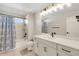Bright bathroom with white vanity, modern fixtures, and a shower-tub combo offers style and functionality at 4644 S Kipling Cir, Littleton, CO 80123