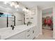 Modern bathroom with double sinks, white cabinets, and a walk-in shower and closet at 4644 S Kipling Cir, Littleton, CO 80123