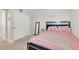 Bedroom with pink bedding, decorative headboard, and sliding closet doors provides comfort and convenience at 4644 S Kipling Cir, Littleton, CO 80123